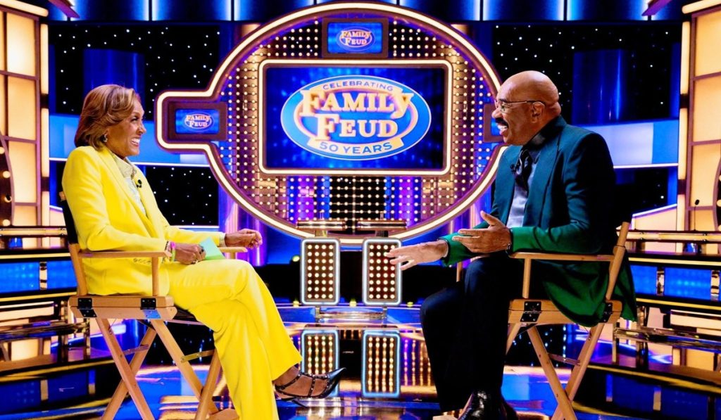 Steve Harvey being interviewed by ABC's Robin Roberts during the 50th anniversary of Family Feud. He has hosted the game show for 16 years.