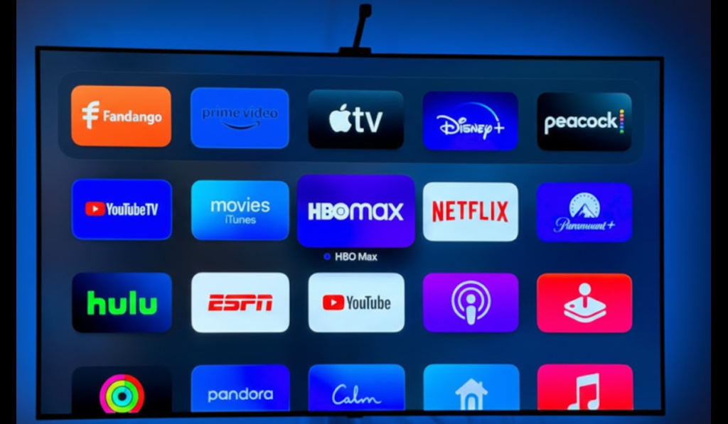 A TV screen showing different streaming apps, including Fandango